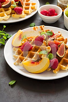 Homemade Belgian waffles with peach, raspberry, fig and honey