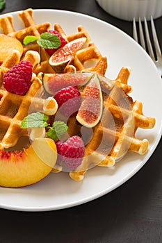 Homemade Belgian waffles with peach, raspberry, fig and honey