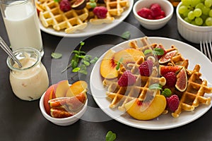 Homemade Belgian waffles with peach, raspberry, fig and honey