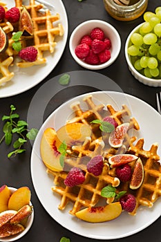 Homemade Belgian waffles with peach, raspberry, fig and honey
