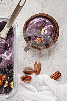 Homemade berry ice cream in a glass container. Vegan blackberry