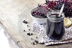 Homemade black elderberry syrup in glass jar