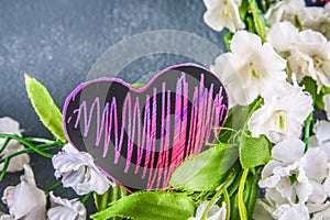 Homemade Black violet pink hearts on a gray concrete background. The concept of Valentine's Day. A symbol of love.