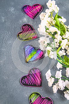 Homemade Black violet pink hearts on a gray concrete background. The concept of Valentine's Day. A symbol of love.