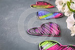 Homemade Black violet pink hearts on a gray concrete background. The concept of Valentine's Day. A symbol of love.