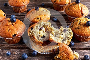 Homemade Blueberry Muffins with fresh berries on wooden table. selected focus