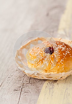 Homemade bread in basket on wooden table