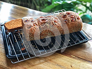 Homemade bread and knife on black tray with Natural light . Healthy bread.