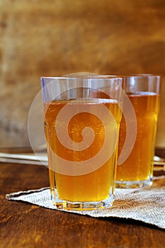 Homemade bread kvass on brown background.