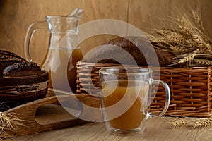 Homemade bread kvass. Summer carbonated soft drink. Glass and carafe on a wooden table. Black Overseas Rye Bread - Ingredients for