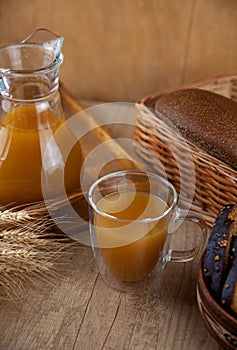 Homemade bread kvass. Summer carbonated soft drink. Glass and carafe on a wooden table. Black Overseas Rye Bread - Ingredients for