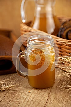 Homemade bread kvass. Summer carbonated soft drink. Glass and carafe on a wooden table. Black Overseas Rye Bread - Ingredients for