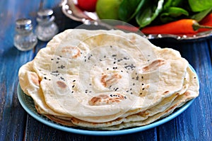 Homemade bread pita bread on a blue background.