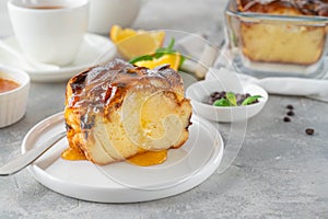 Homemade bread pudding with chocolate chips on a gray concrete background. Selective focus, copy space.