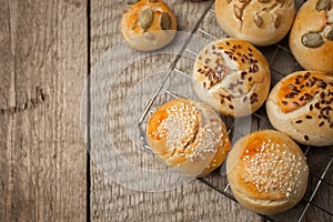 Homemade burger bun on bakery parchment . Food photography, concept of homemade fresh bakery. Rolls with sesame seeds hamburger