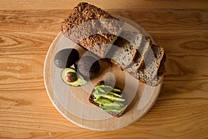 Homemade bread is sliced and layered with avocado