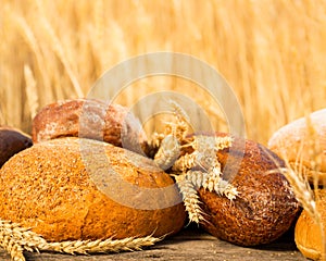 Homemade bread and wheat on the wooden table