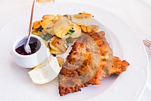 A Homemade Breaded German Weiner Schnitzel with cooked Potatoes