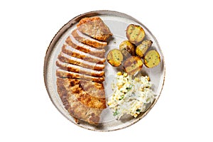 Homemade breaded german weiner schnitzel with potatoes and salad. Isolated on white background.