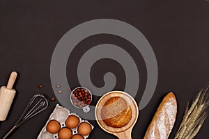 Homemade breads or bun, croissant and bakery ingredients, flour, almond nuts, hazelnuts, eggs on dark background, Bakery backgroun