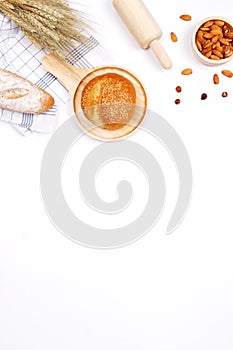 Homemade breads or bun, croissant and bakery ingredients, flour, almond nuts, hazelnuts, eggs on white background, Bakery