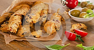 Homemade BreadSticks on a rustic wooden board.