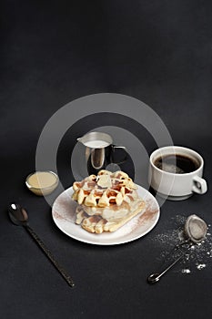 Homemade of Breakfast tasty Waffles, Caramel Sauce, Coffee Cup, Milk, dessertspoon, strainer