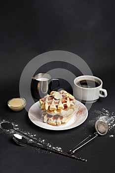 Homemade of Breakfast tasty Waffles, Caramel Sauce, Coffee Cup, Milk, dessertspoon, strainer