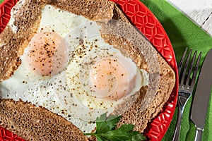 Homemade Breton crepe with egg in red plate