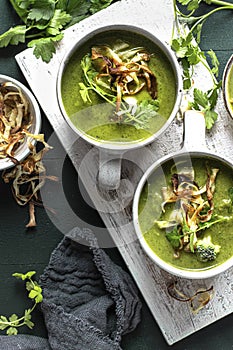 Homemade broccoli soup with horseradish and parsley chips