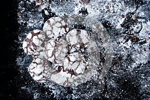Homemade brownies with sugar icing on black slate. Chocolate brownie cookies cakes on a texture background. Cook at home. A lot of