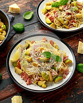 Homemade Brussels sprouts, bacon, pancetta pasta with parmesan cheese. On wooden table