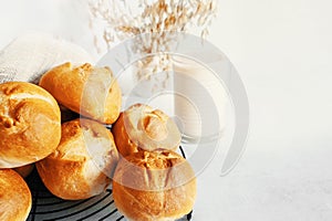 homemade buns. Homemade buns on a wooden board with wheat ears. Homemade buns for dinner, boiled with vegetable milk.