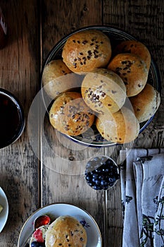 Homemade buns with linseed sunflower seeds for breakfast with butter and blueberry jam