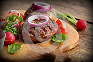 Homemade burger with beef cutlet, vegetables, onion and herbs on wooden cutting board , vintage filtered