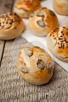 Homemade burger bun on bakery parchment . Food photography, concept of homemade fresh bakery. Rolls with sesame seeds hamburger