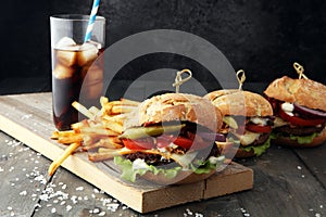 Homemade burger with fries and icy soft drink.