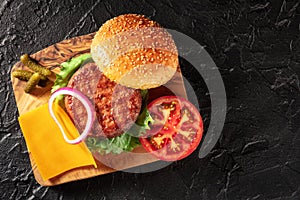 Homemade burger. Hamburger ingredients, overhead flat lay shot on a wooden board