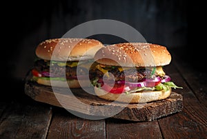 Homemade burgers on rustic wood background close up