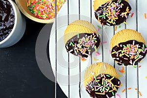 homemade butter cookies dipped in chocolate and sugar sprinkle.