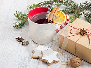 Homemade butter nuts star shaped cookies with icing, pine, orange slices,cinnamon, anise and walnuts over white wood background.