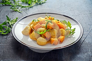 Homemade Butternut squash gnocchi with wild rocket in a plate