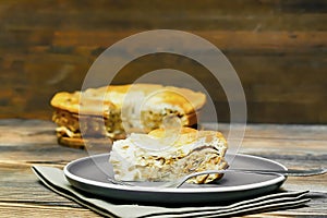 homemade cabbage pie, piece of tart on plate on wooden rustic table. cooking baking pastry receipe. Autumn winter vegetable