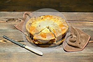 Homemade cabbage vegetable pie, tart with knife on wooden rustic table. cooking baking pastry receipe. Autumn winter photo