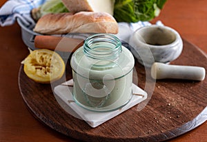 Homemade caesar dressing in a glass jar.