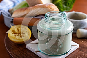 Homemade caesar dressing in a glass jar.