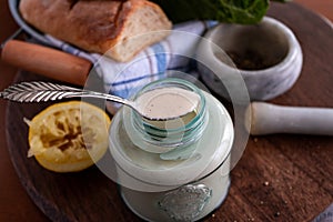 Homemade caesar dressing in a glass jar.