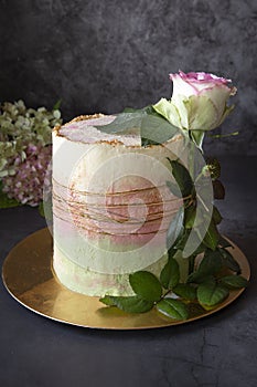 Homemade cake.The birthday cake is decorated with a live rose on a dark background. Gifts