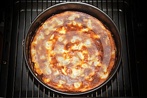 Homemade cake just finished in the oven, view from above, dark b