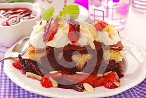 Homemade cake with plums and whipped cream